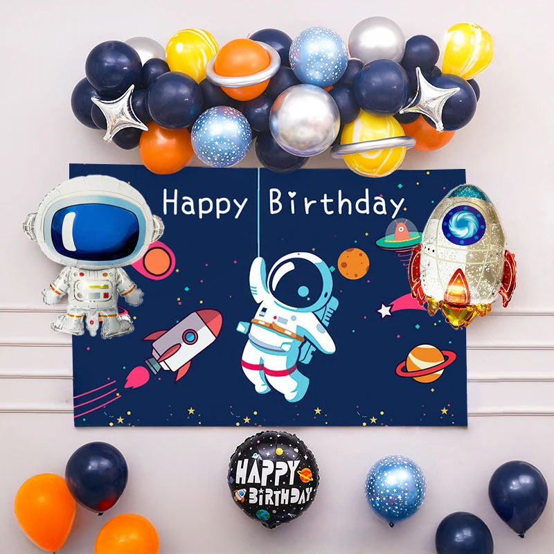 Space-themed birthday banner with astronaut design, surrounded by colorful balloons on a white background.