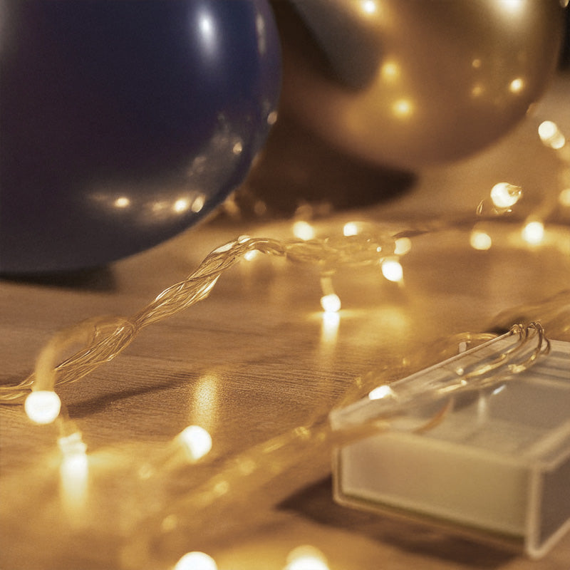 String lights on a wooden surface with a blurred background