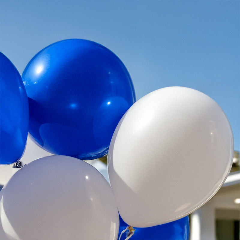Blue and white balloons against a clear blue sky