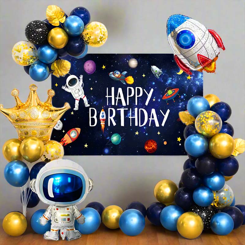 Space-themed birthday party setup with balloons, astronaut decorations, and a 'Happy Birthday' banner.