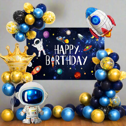 Space-themed birthday party setup with balloons, astronaut decorations, and a 'Happy Birthday' banner.